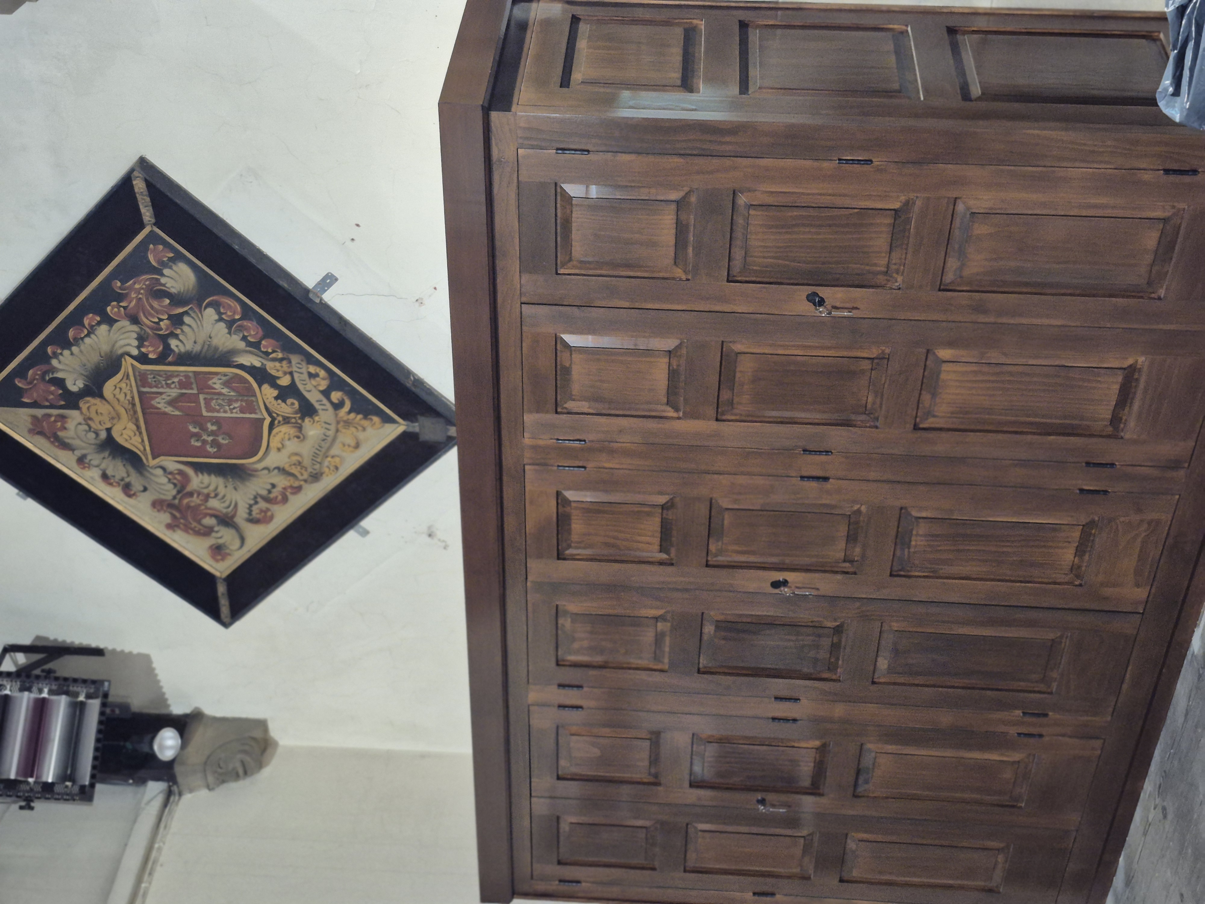 Dark timber panelled cabinetry and crest detail
