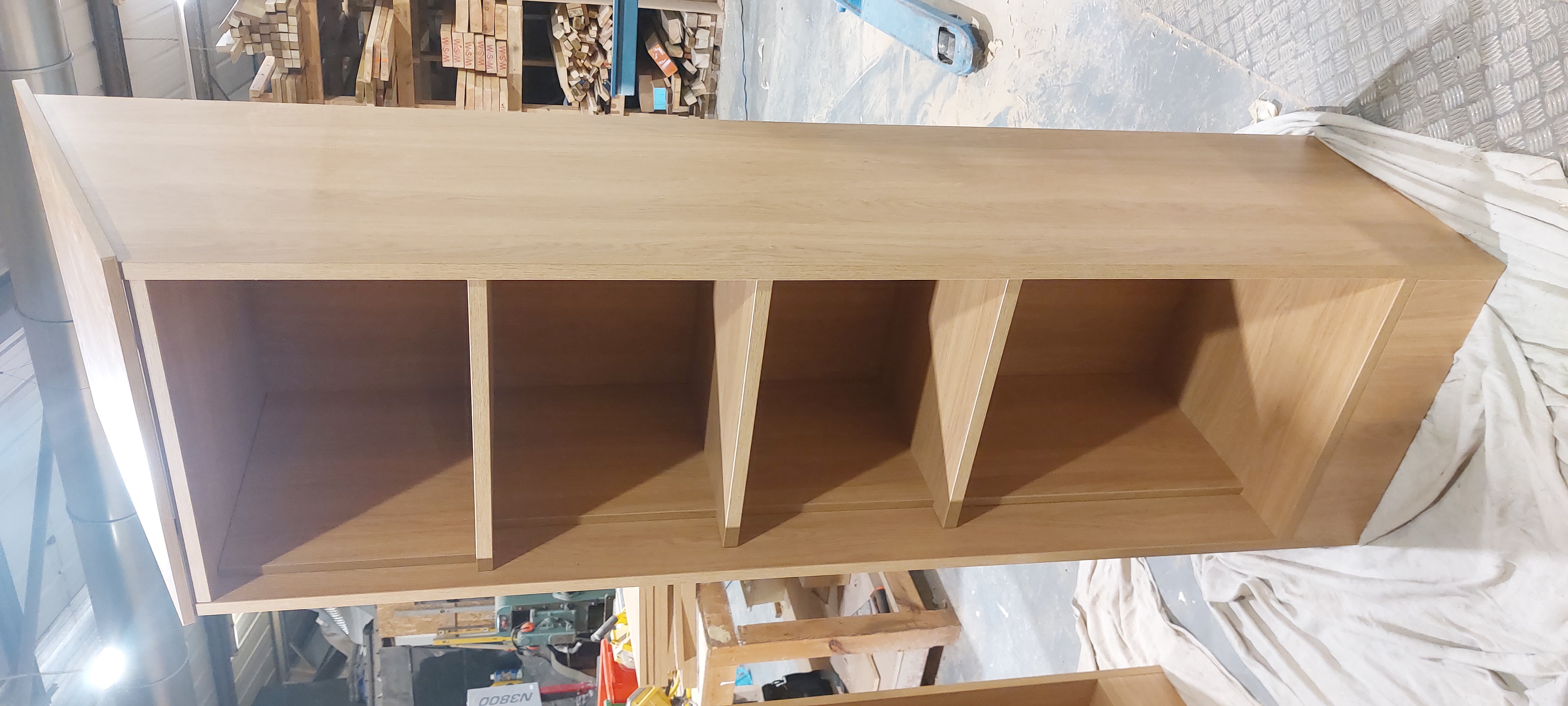 Long oak shelving unit in the workshop
