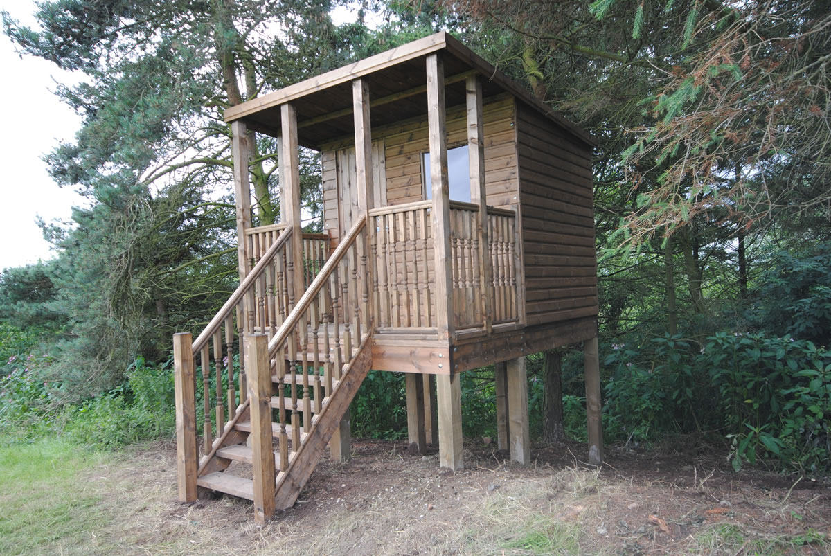 Raised timber treehouse among trees